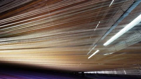 Yarn thread lines on the weaving loom machine in textile factory. Textile Stock Footage 204792185