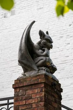 Yaroslavl, Russia. A brooding gargoyle sculpture perched atop a brick pilla.. Stock Photos