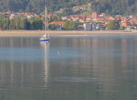 Yatch with beach in the background Stock Photos