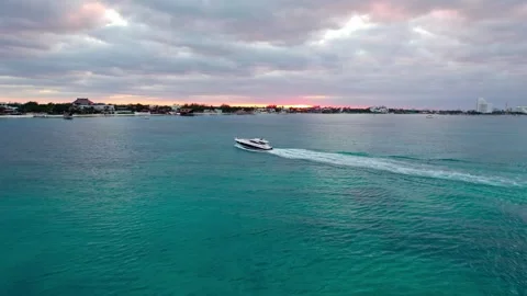 Yatch cruising in front of sunset with turquoise water 4K Stock Footage 314753925