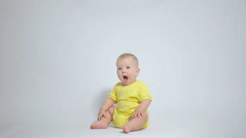 A yawning child on a light background Stock Footage 244843507