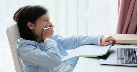 Yawning Schoolboy Working on Homework at the Table Stock Footage 250027046