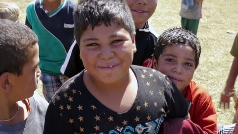 Yazidi refugee kids posing for the camera in a refugee camp Stock Footage 77753424