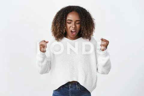 Yeah go woman power. Portrait of cute emotive and excited charismatic dark Stock Photos