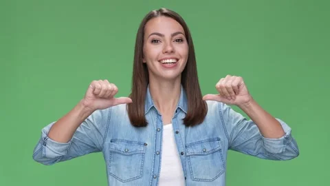 Yeah it is me lady point thumbs her self isolated green color background Stock Footage 166043873