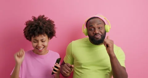 Yeah its our song. Optimistic glad woman turns on music from playlist on mobile Stock Footage 149917325