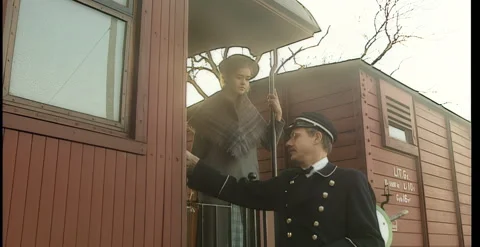Year 1920. The station master waves the train off. 스톡 동영상 330740105