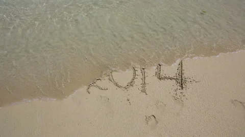Year 2014 number washed off by wave Stock Footage 43034960