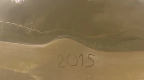 Year 2015 written on sand at sunset, aerial view Stock Footage 45368379