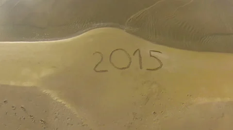 Year 2015 written on sand at sunset, aerial view Stock Footage 45368586
