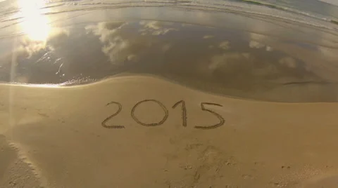 Year 2015 written on sand at sunset, aerial view Stock Footage 45369991
