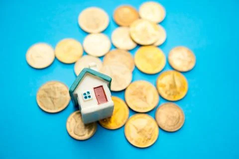 Year 2018 wooden block with stack coins and mini house Stock Photos