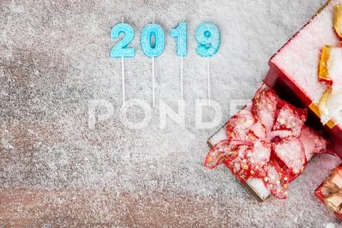 Year 2019 blue color overlay on wood board, red gift boxes at the side have s Stock Photos