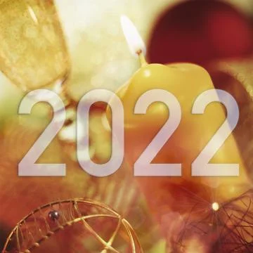 Year 2022 on a background of Christmas elements in warm tones. Stock Photos