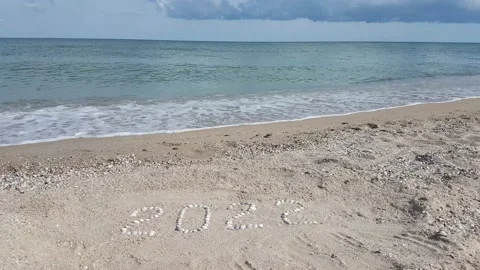 Year 2022 written from seashells on the shore Stock Footage 156701285