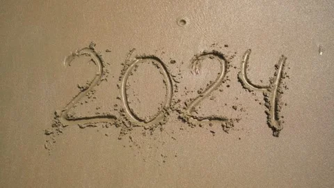 The Year 2024 Getting Written in Beautiful Sand at the Sunny Beachside Shoreline Stock Footage 294686791