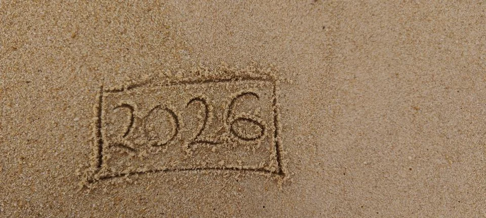 The year 2026 is handwritten on a sandy beach Stock Photos