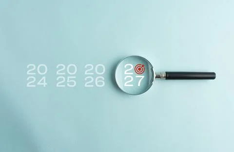Year 2027 highlighted through a magnifying glass among previous years, repr.. Stock Photos