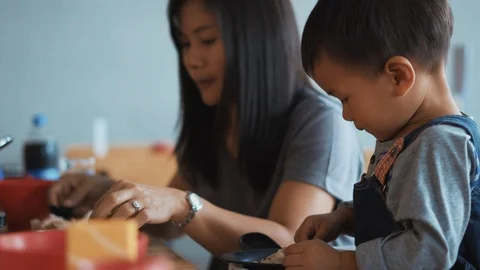 A year and 11 months old Asian baby eating food Stock Footage 86511789