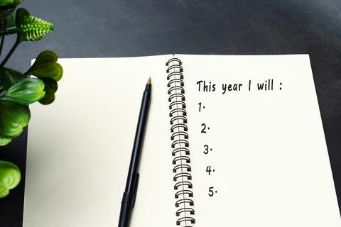 This year i will list on notepad. New year goals concept. Stock Photos