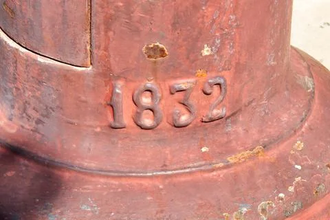 Year mark on the iron base of a lamppost in a public garden Stock Photos