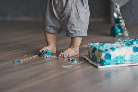 A year-old child plays with elements of the cake 9234. Stock Photos