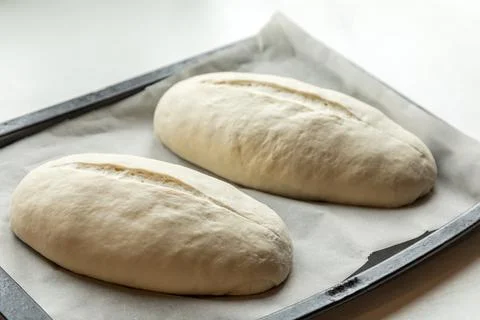 Yeast buns on a baking sheet Stock Photos