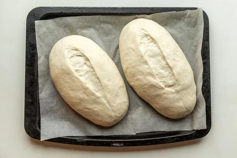 Yeast buns on a baking sheet Stock Photos