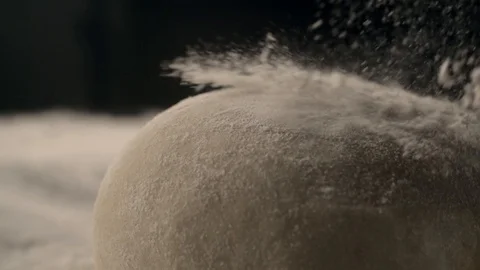 Yeast dough with flour on the kitchen table, cooking food in dark key, cooking Stock Footage 120170980