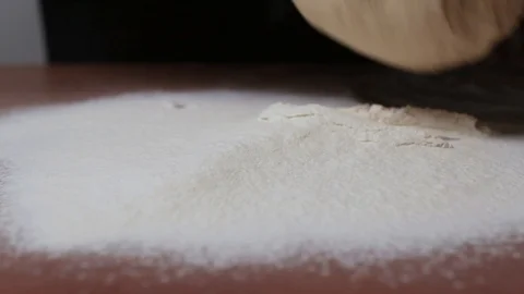 Yeast dough flows into flour on the table Video stock 124960226