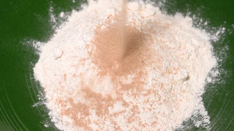 Yeast is poured into flour Stock Footage 252458481
