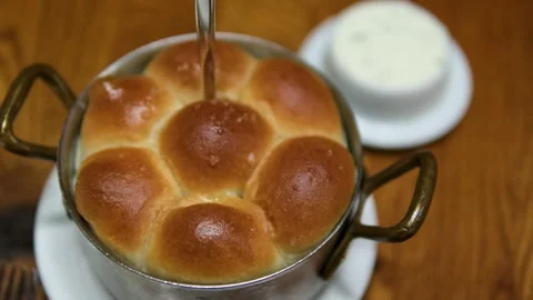 Yeast rolls buns with parmesan cheese. Brush buns with a melting butter and dill Stock Footage 302108848