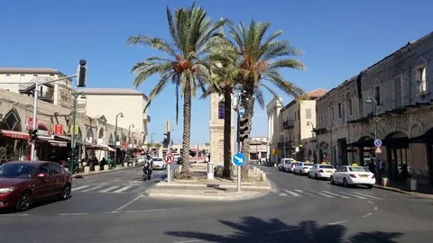 Yefet Street in Jaffa, clock tower, palm trees, cars, road, shops, sunny day Vídeos de archivo 80254975