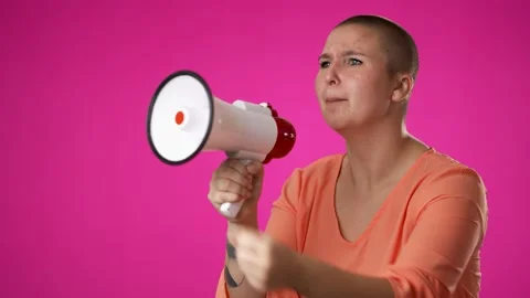 Yelling into megaphone side profile view of excited gender fluid non binary Stock Footage 222772177