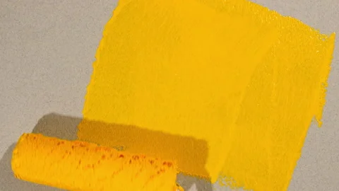 Yellow acrylic paint on a gray background. Abstract yellow watercolor brush Video stock 168004752