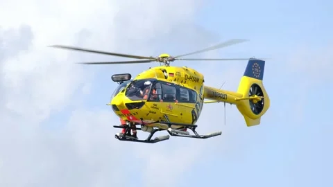 Yellow ADAC rescue helicopter hovering in the air, emergency infrastructure. Stock Footage 177530309