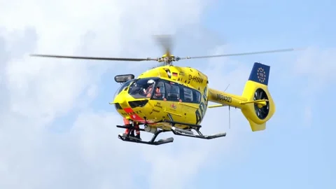 Yellow ADAC rescue helicopter hovering in the air Stock Footage 181546411