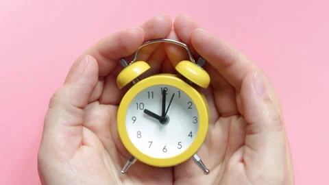 Yellow alarm clock on pink background close-up, top view Stock Footage 161783820