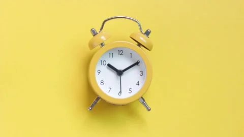 Yellow alarm clock on a yellow background close-up, top view Stock Footage 139081028