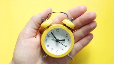 Yellow alarm clock on yellow background close-up, top view Stock Footage 161462301