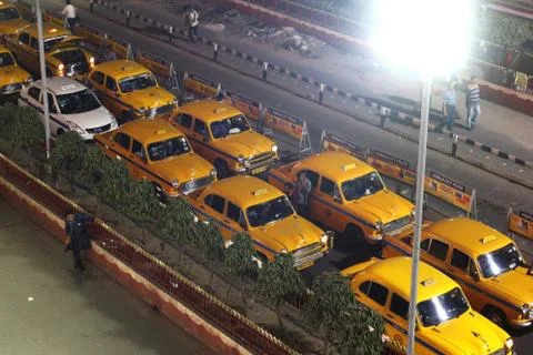 Yellow ambassador taxi of Kolkata in street at night. Stock Photos