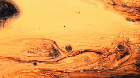 Yellow and black psychedelic patterns of multi-colored paints mixed with each Stock Footage 123743966