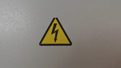 Yellow and black triangular sticker signaling the danger of high voltage Stock Footage 346311207