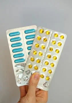 Yellow and blue complex of vitamins and minerals Foto stock