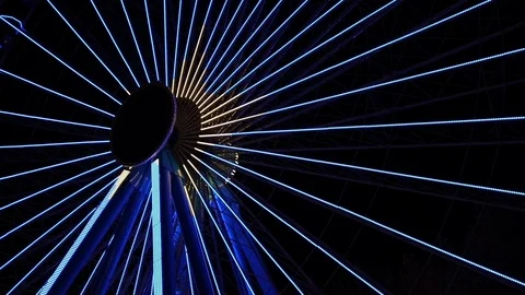 Yellow and blue light show on ferris wheel at night Stock Footage 123071042