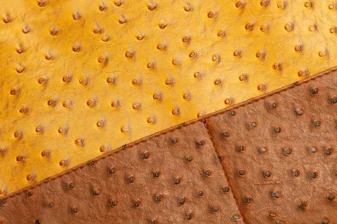 A yellow and brown with lumps leather fabric in a close up view Stock-Fotos