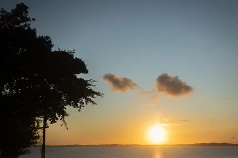 Yellow and dramatic sunset on a beautiful beach. Stock Photos