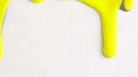 Yellow and gray mixed drops of paint flow down on white canvas. Abstract ar.. Stock Footage 250517088