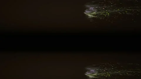 Yellow and green splashes moving in a horizontal manner on the dark background. Stock Footage 131160705
