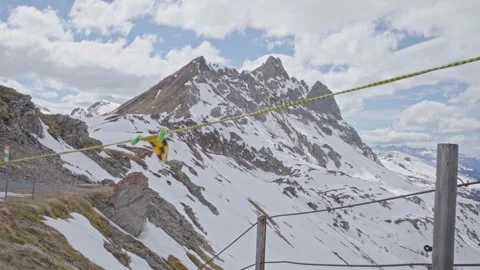 Yellow and green windsock flapping in the wind on snowy mountain Stock Footage 310164036